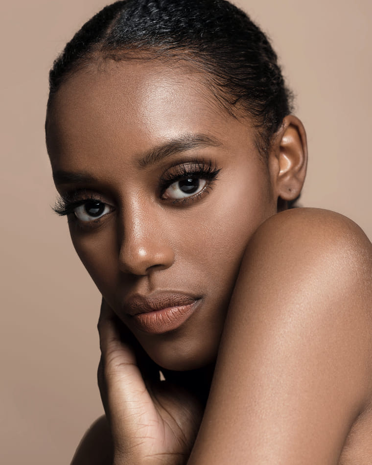 A composed portrait in warm daylight, the face turned to the camera